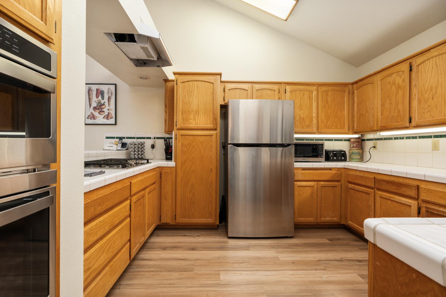 53050 Ridge Top Drive North Fork, CA 93643 - Photo 25 of 52 a kitchen with cabinets a refrigerator and a stove top oven
