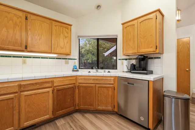 a kitchen with a sink cabinets and window