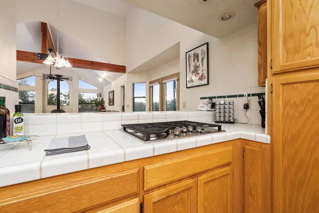 a kitchen with stainless steel appliances granite countertop a stove and a cabinets