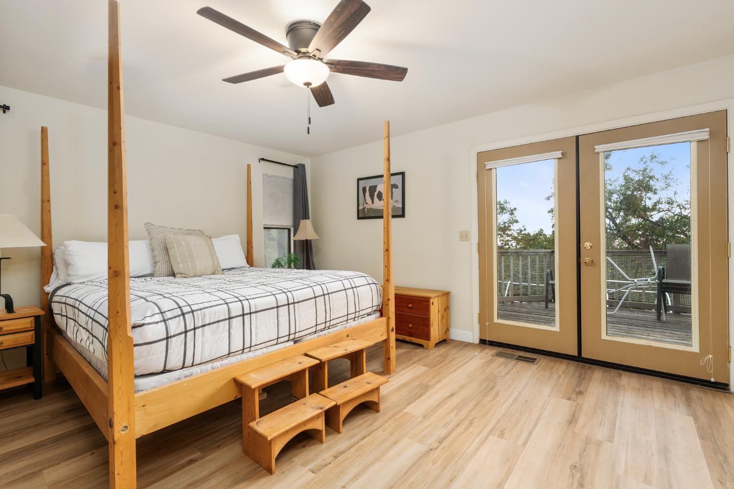 53050 Ridge Top Drive North Fork, CA 93643 - Photo 30 of 52 a bedroom with a large bed a chandelier and windows