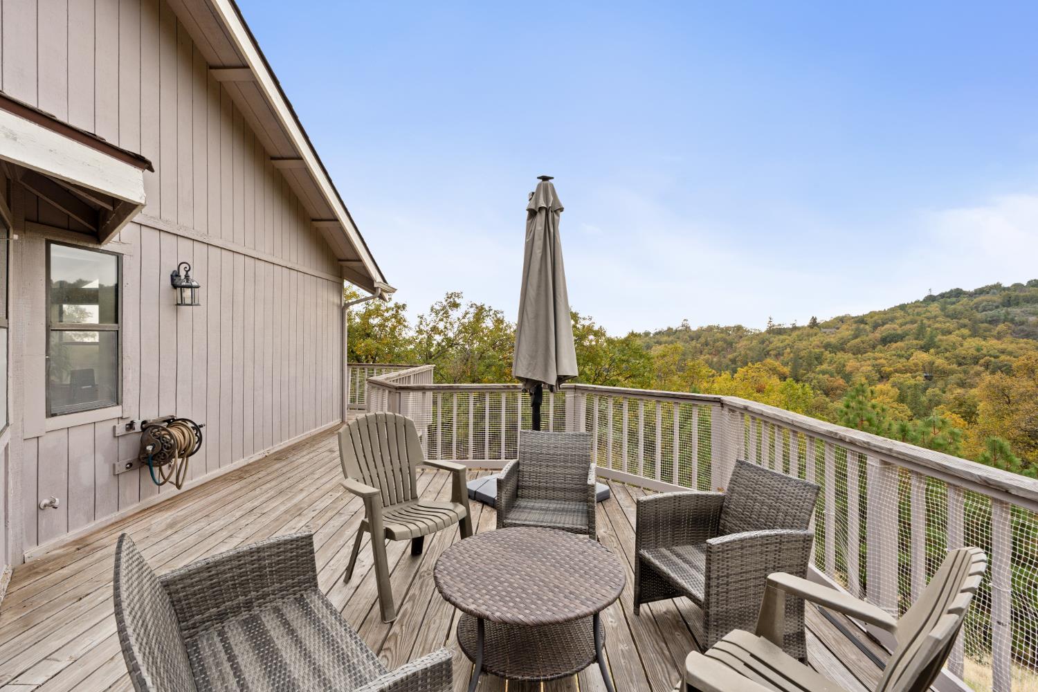 53050 Ridge Top Drive North Fork, CA 93643 - Photo 43 of 52 a view of a balcony with chair and wooden floor