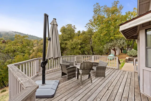 a view of balcony with wooden floor and outdoor seating