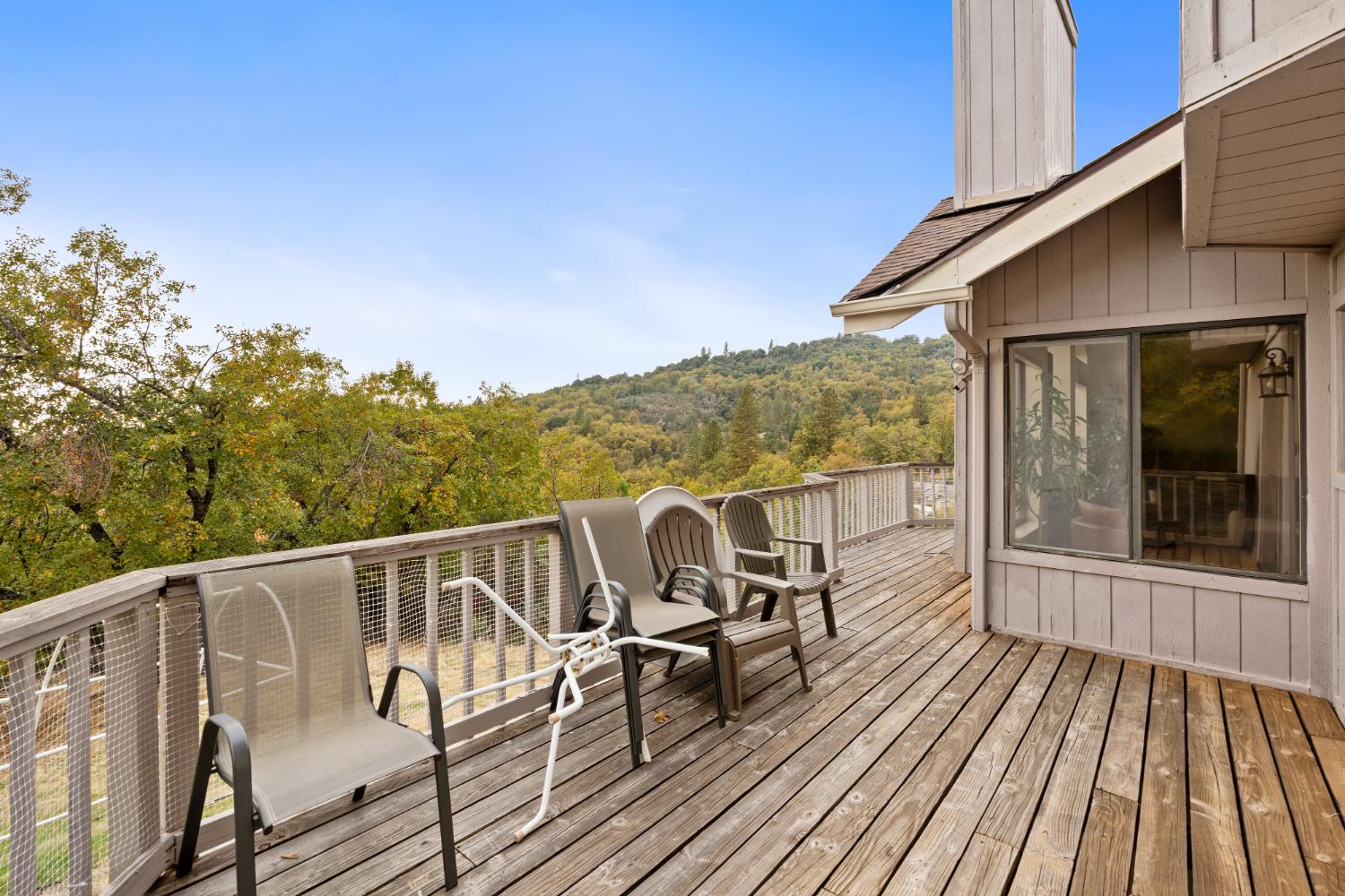 53050 Ridge Top Drive North Fork, CA 93643 - Photo 48 of 52 a view of a balcony with chairs and wooden floor