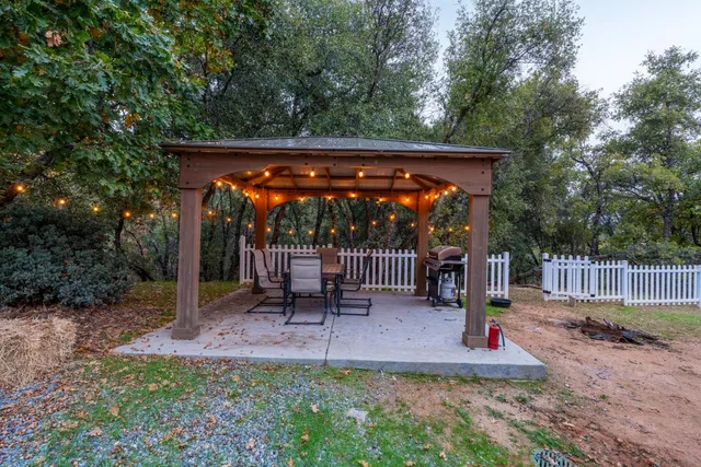 a view of backyard with a table and chairs