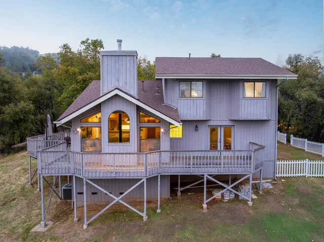 a view of a house with roof deck and couches