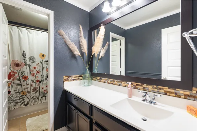 a bathroom with a bathtub a double vanity sink and mirror