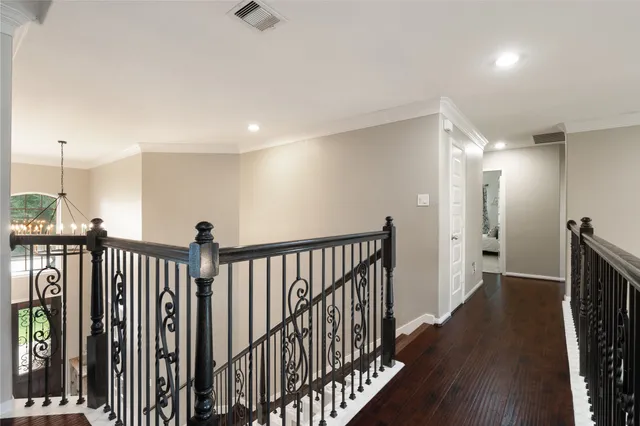 a bedroom with bed cabinets and wooden floor