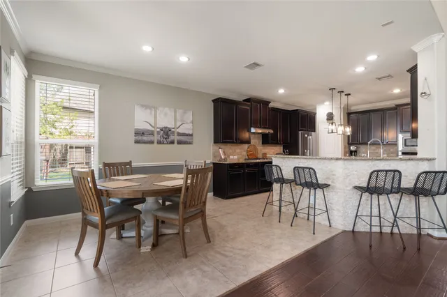 a view of a dining room with furniture and a potted plant