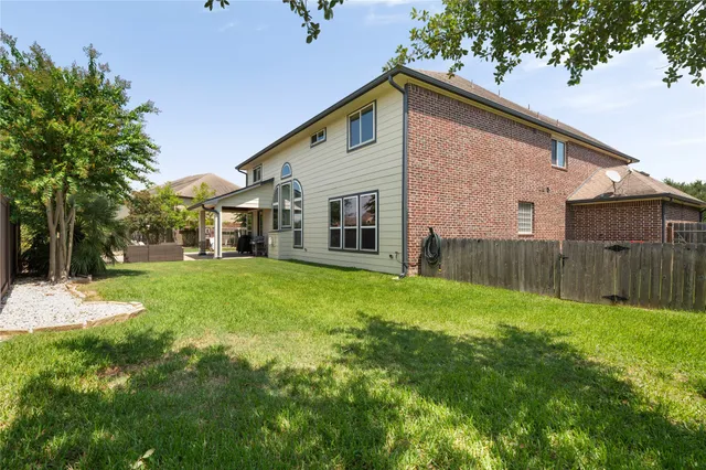 front view of a house with a yard and potted plants