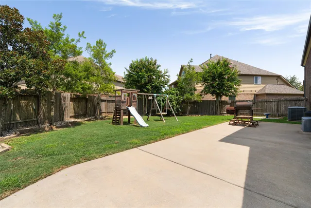 a living room with patio furniture and a floor to ceiling window