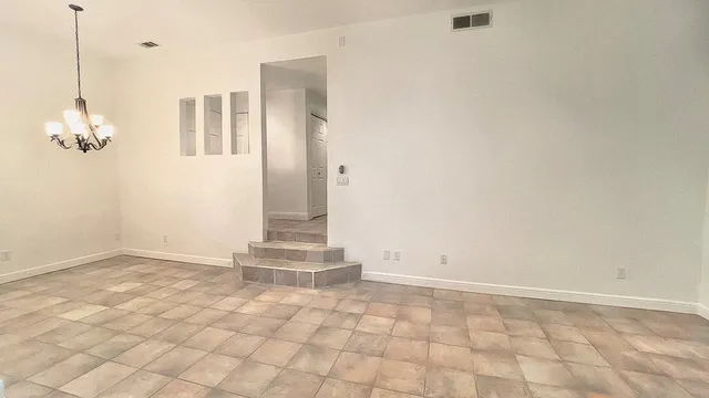 a view of a room with wooden floor and windows