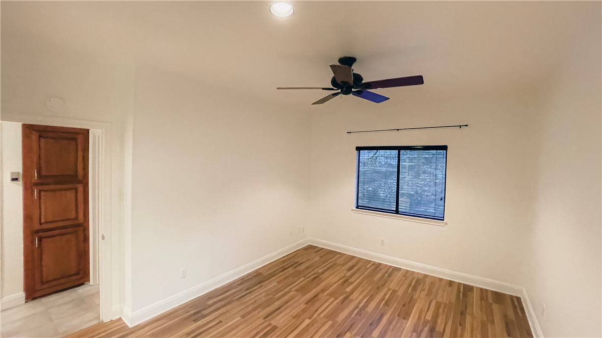 8200 Neely Drive, Unit 155 Austin, TX 78759 - Photo 9 of 17 a view of empty room with wooden floor and fan