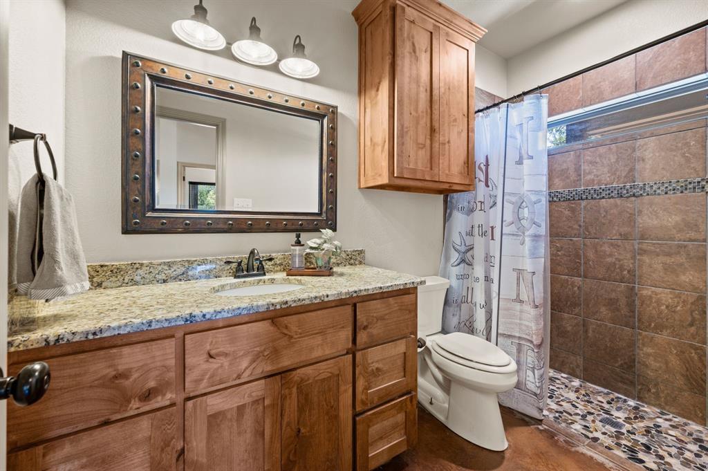 3019 Fm 718 Newark, TX 76071 - Photo 25 of 40 a bathroom with a granite countertop sink mirror vanity and toilet