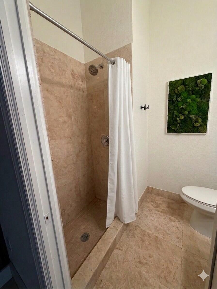 17296 Northwest 88th Court, Unit STUDIO Hialeah, FL 33018 - Photo 4 of 12 a bathroom with a shower and a toilet