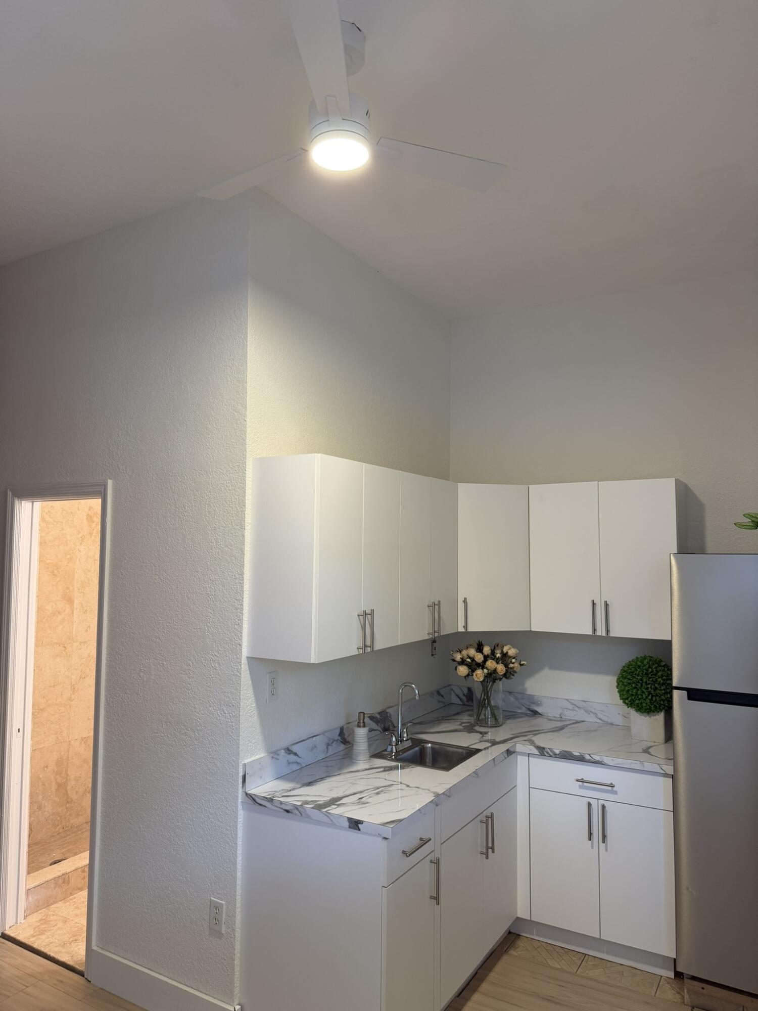 17296 Northwest 88th Court, Unit STUDIO Hialeah, FL 33018 - Photo 6 of 12 a kitchen with a sink and cabinets