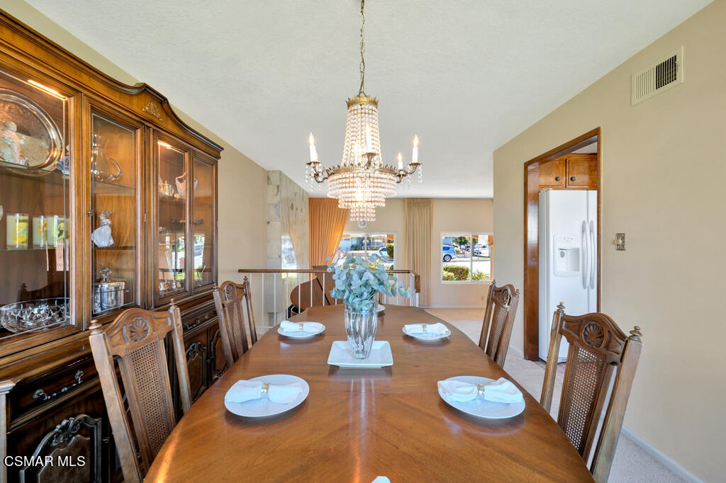 4135 Springfield Street Simi Valley, CA 93063 - Photo 14 of 41 a view of a dining room with furniture a chandelier and wooden floor