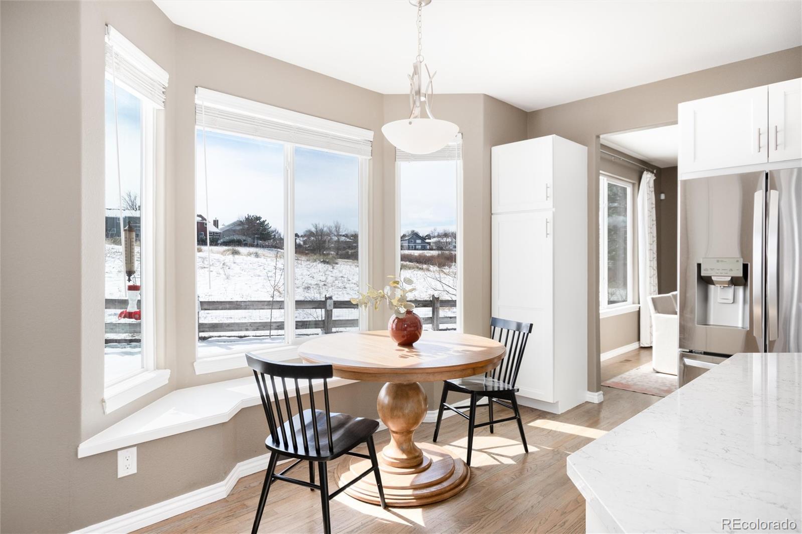 9486 South Autumn Ash Place Highlands Ranch, CO 80126 - Photo 17 of 50 a dining room with furniture window and wooden floor
