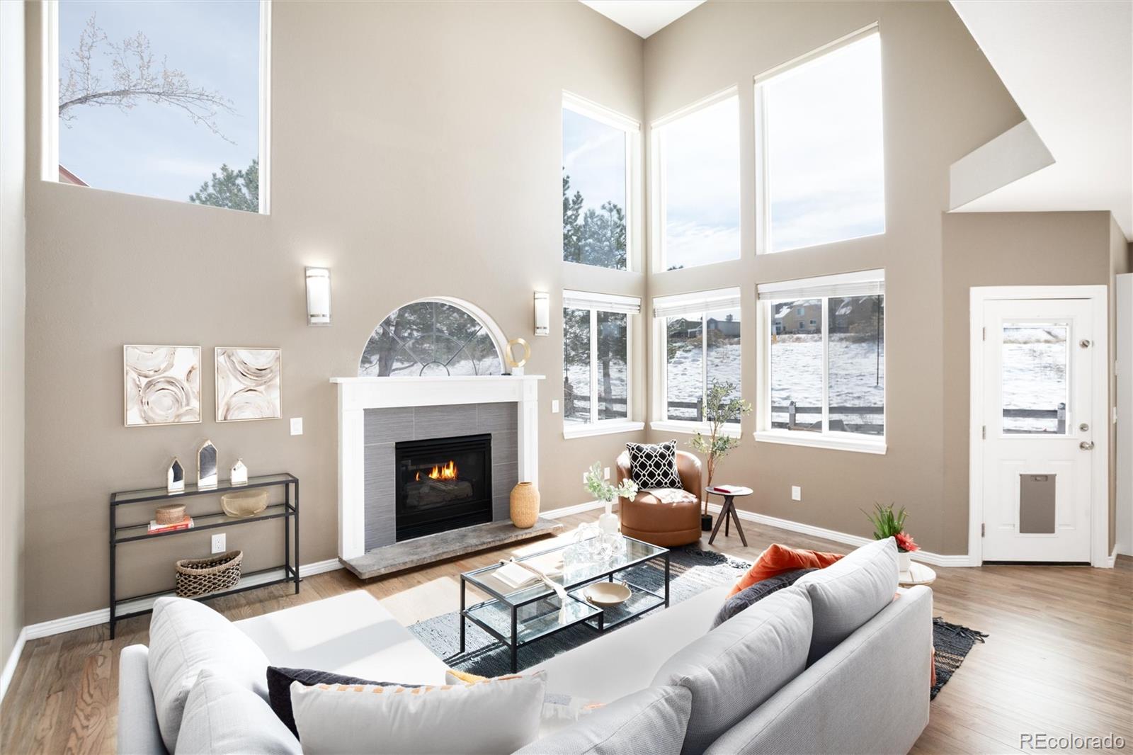 9486 South Autumn Ash Place Highlands Ranch, CO 80126 - Photo 20 of 50 a living room with furniture a fireplace and a large window