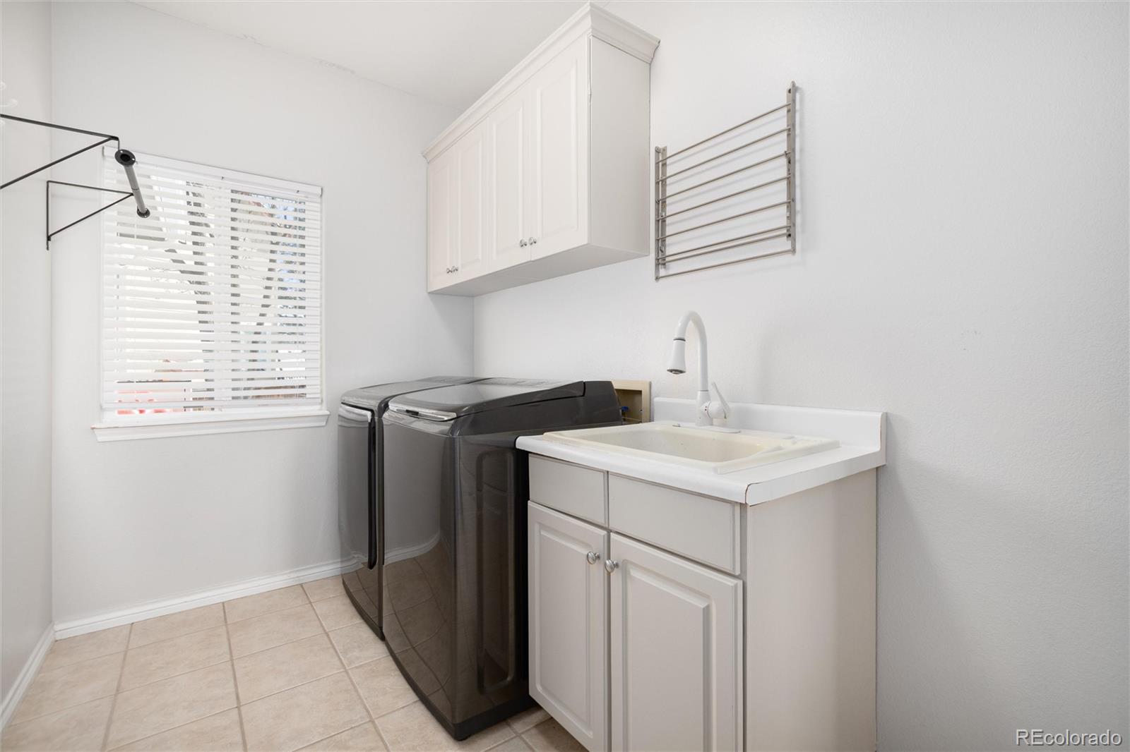 9486 South Autumn Ash Place Highlands Ranch, CO 80126 - Photo 25 of 50 a utility room with a sink washer and dryer