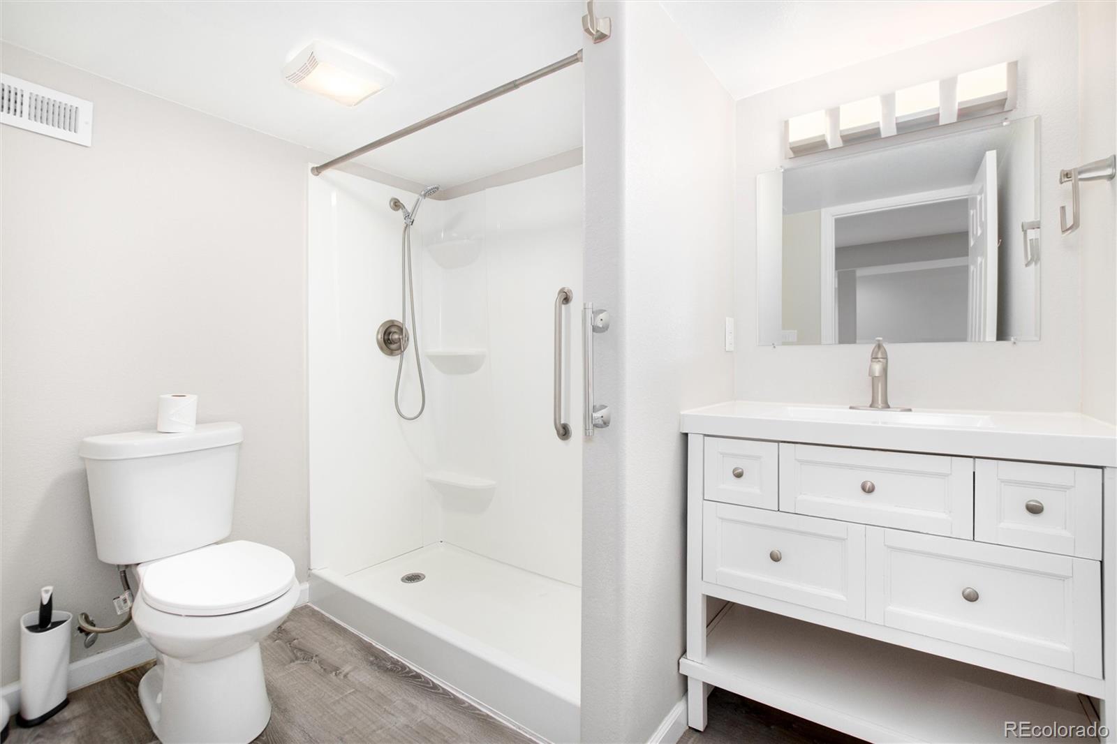 9486 South Autumn Ash Place Highlands Ranch, CO 80126 - Photo 40 of 50 a bathroom with a sink a toilet and shower