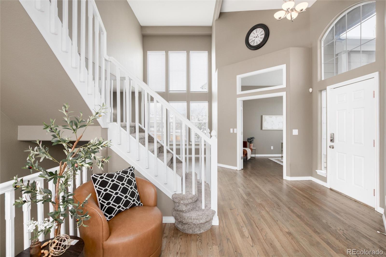 9486 South Autumn Ash Place Highlands Ranch, CO 80126 - Photo 4 of 50 a view of entryway and hall with wooden floor