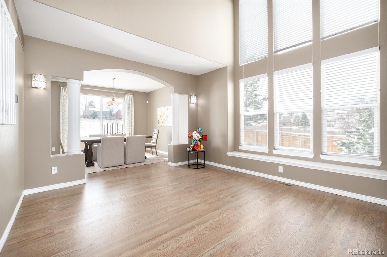 9486 South Autumn Ash Place Highlands Ranch, CO 80126 - Photo 7 of 50 a view of a big room with wooden floor and windows