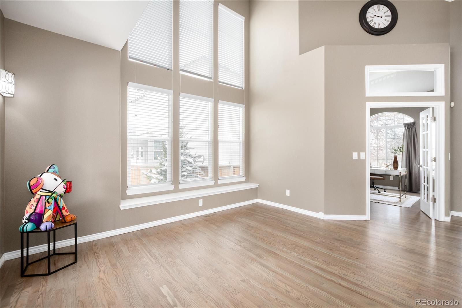 9486 South Autumn Ash Place Highlands Ranch, CO 80126 - Photo 9 of 50 a view of an empty room with wooden floor and a window