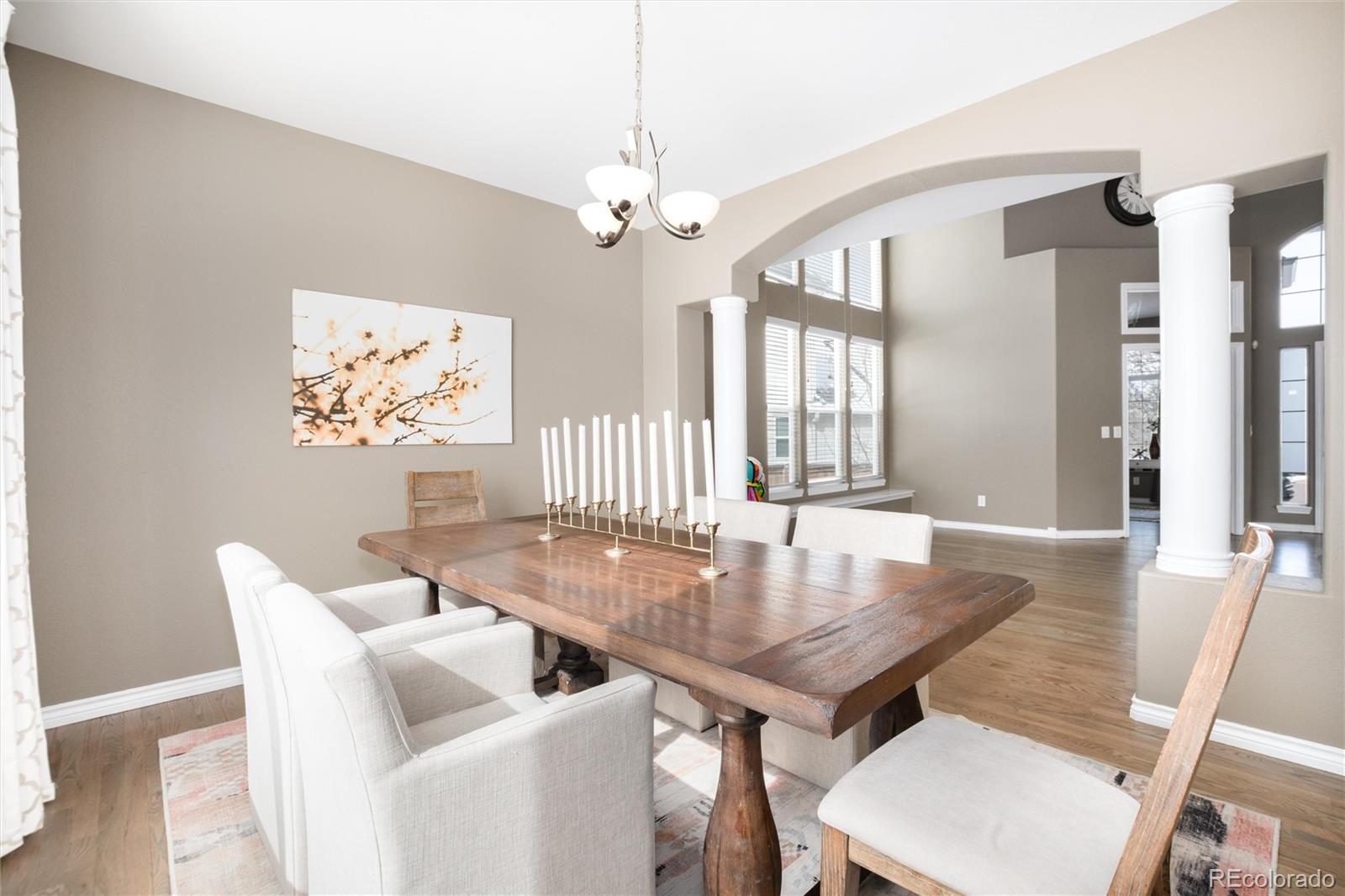 9486 South Autumn Ash Place Highlands Ranch, CO 80126 - Photo 10 of 50 a view of a dining room with furniture and wooden floor
