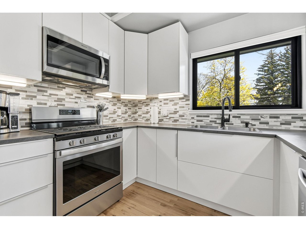 2910 19th Street Boulder, CO 80304 - Photo 11 of 28 a kitchen with stainless steel appliances granite countertop a stove microwave and sink
