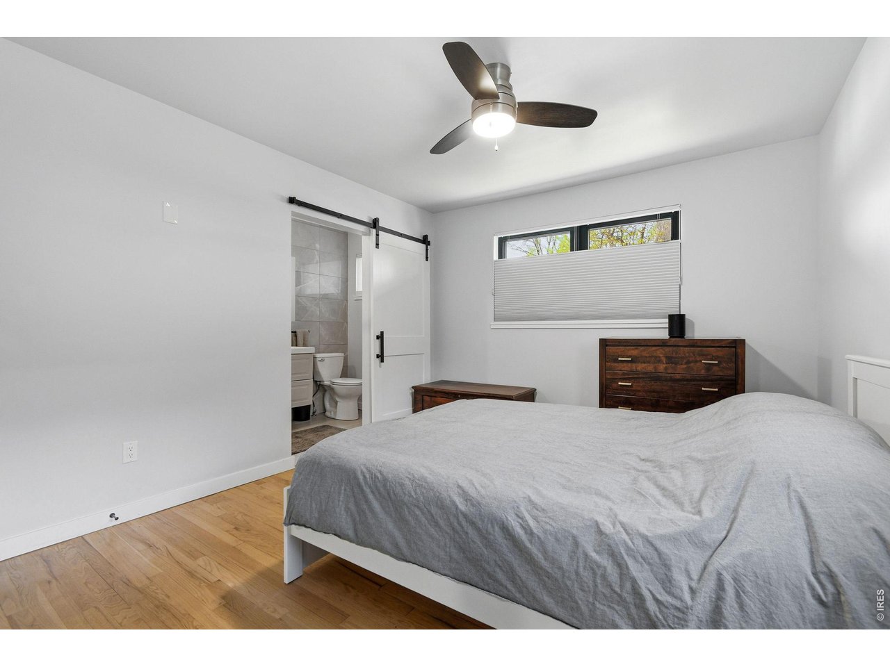 2910 19th Street Boulder, CO 80304 - Photo 13 of 28 a bedroom with a bed and a painting on the wall