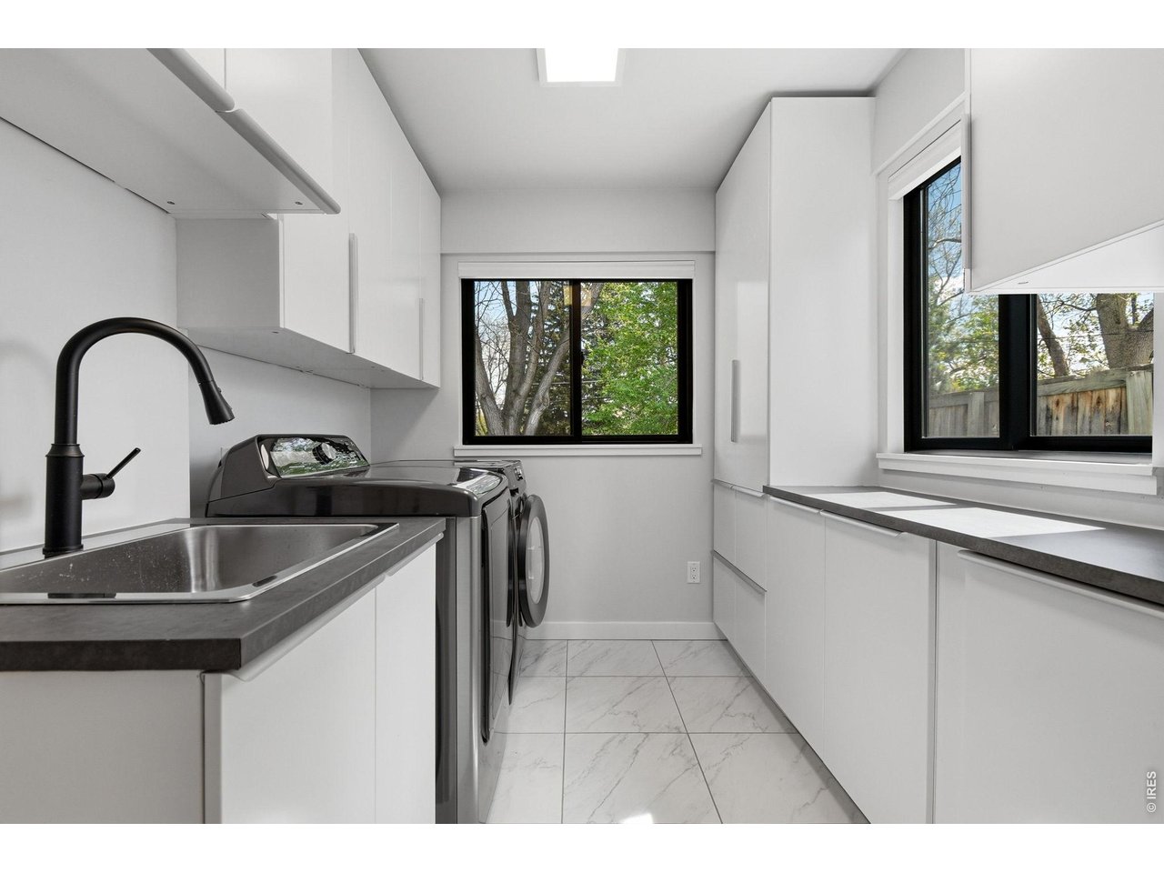 2910 19th Street Boulder, CO 80304 - Photo 22 of 28 a kitchen with a sink a stove and a window