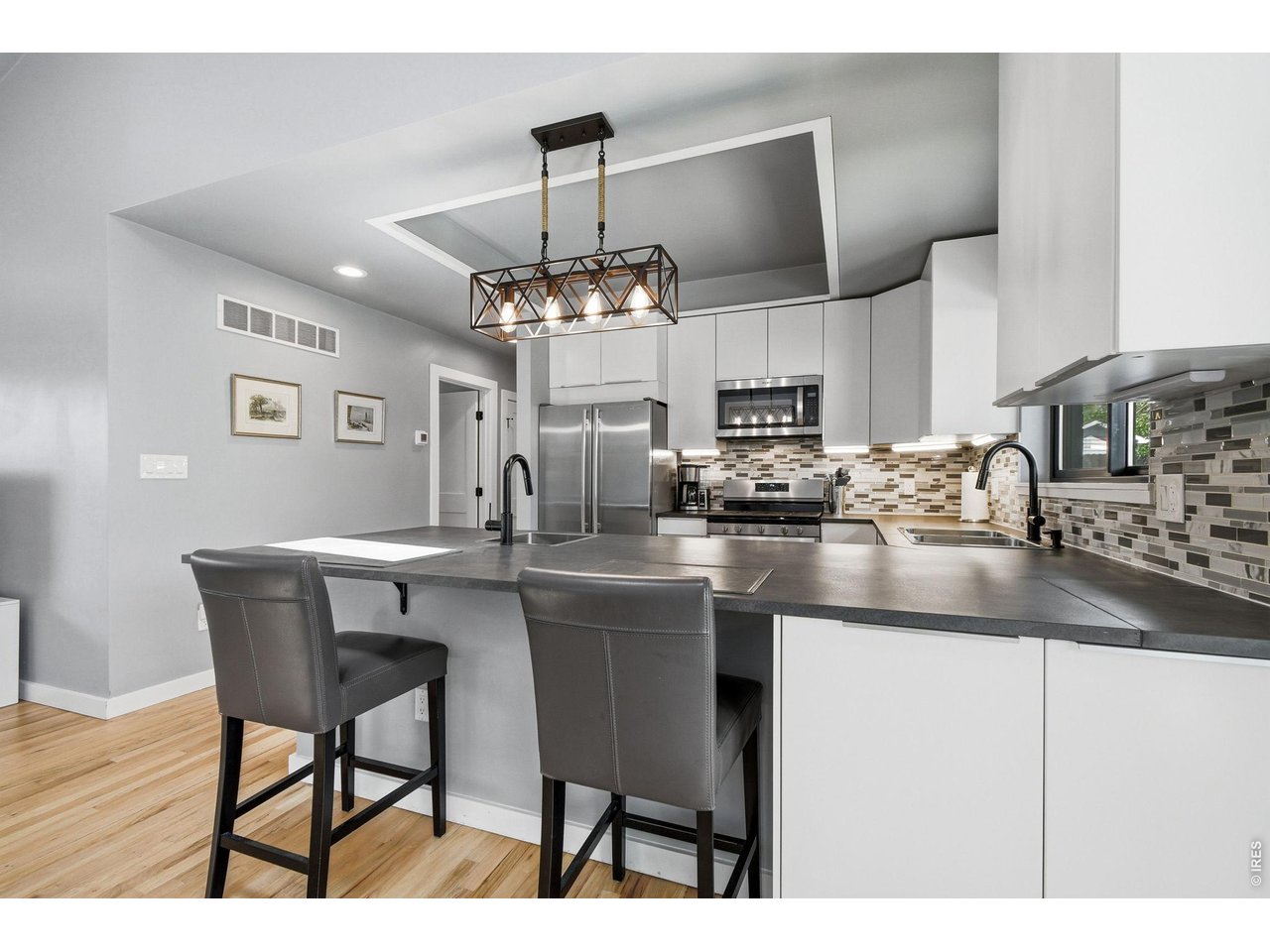 2910 19th Street Boulder, CO 80304 - Photo 9 of 28 a kitchen with kitchen island granite countertop a table and chairs in it