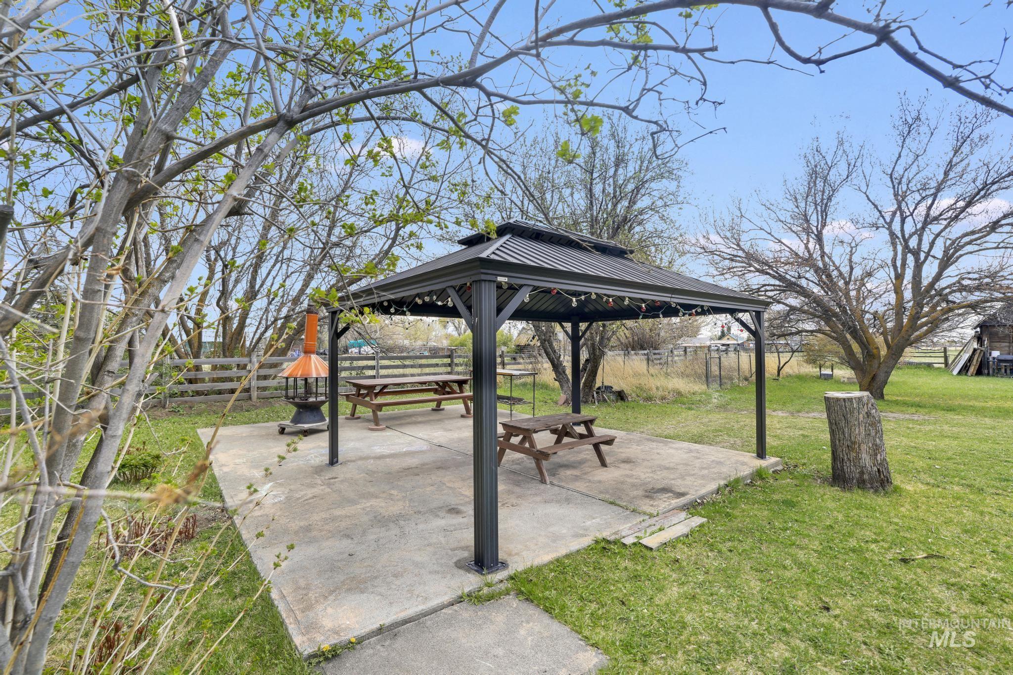 19591 Queen Crown Road Carey, ID 83320 - Photo 27 of 37 Concrete patio featuring a metal gazebo with string lighting