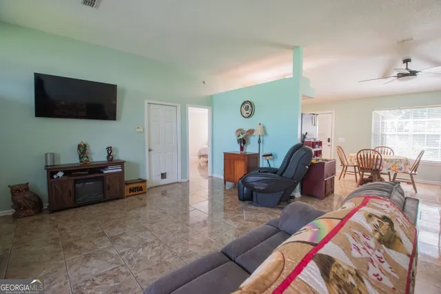 a living room with furniture and a flat screen tv