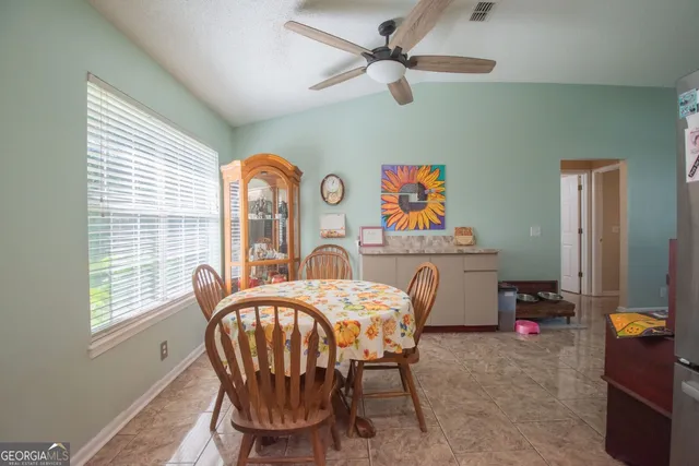 a view of a dining room with furniture and a chandelier