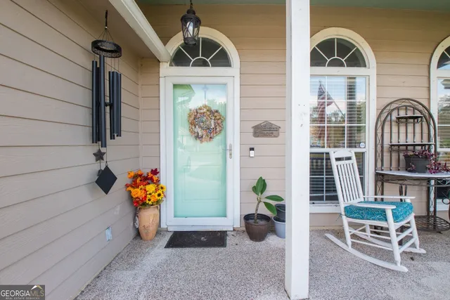 a front view of a house with outdoor seating and plants