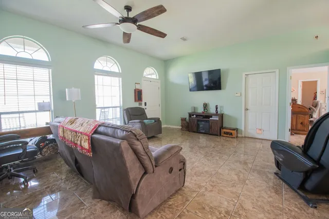 a living room with furniture and a flat screen tv