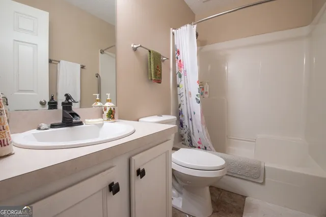 a bedroom with a bed a desk and chair