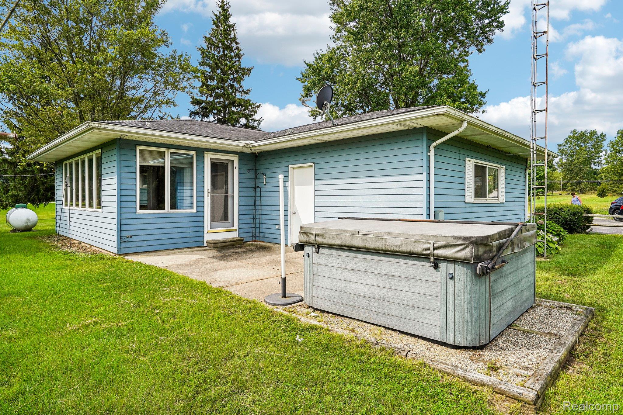 3981 South State Road Durand, MI 48429 - Photo 23 of 33 Single-story residence featuring blue siding, white trim, and a patio area