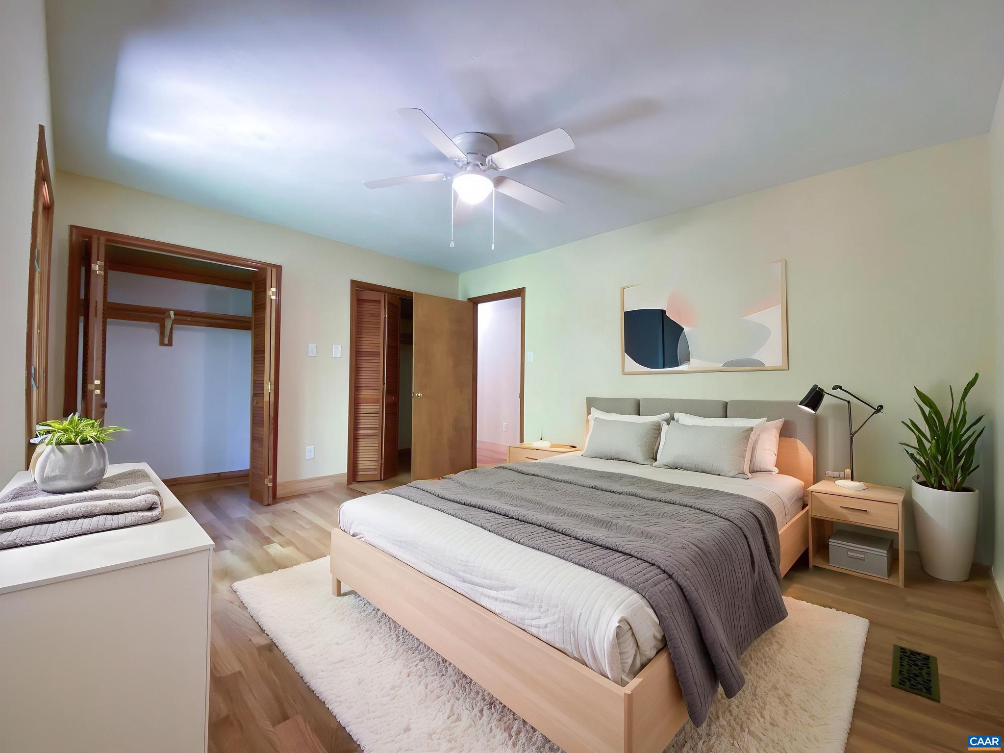 247 Goldenrod Road Ruckersville, VA 22968 - Photo 11 of 35 a bedroom with a large bed and a chandelier