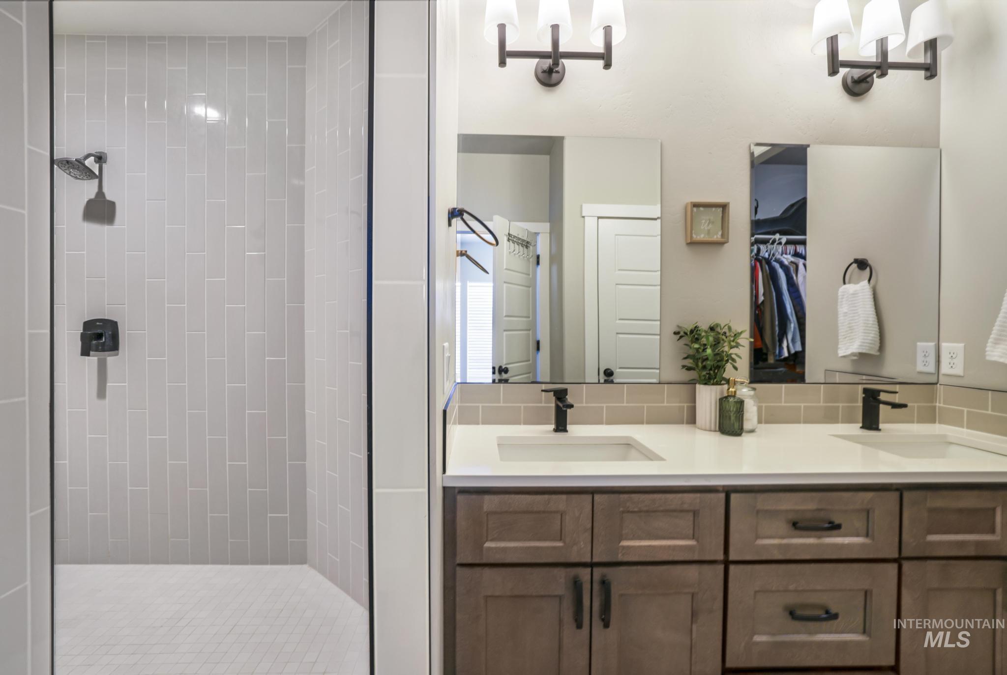 3103 Moonrise Road Twin Falls, ID 83301 - Photo 17 of 40 Bathroom with double vanity, a shower stall, and a walk in closet