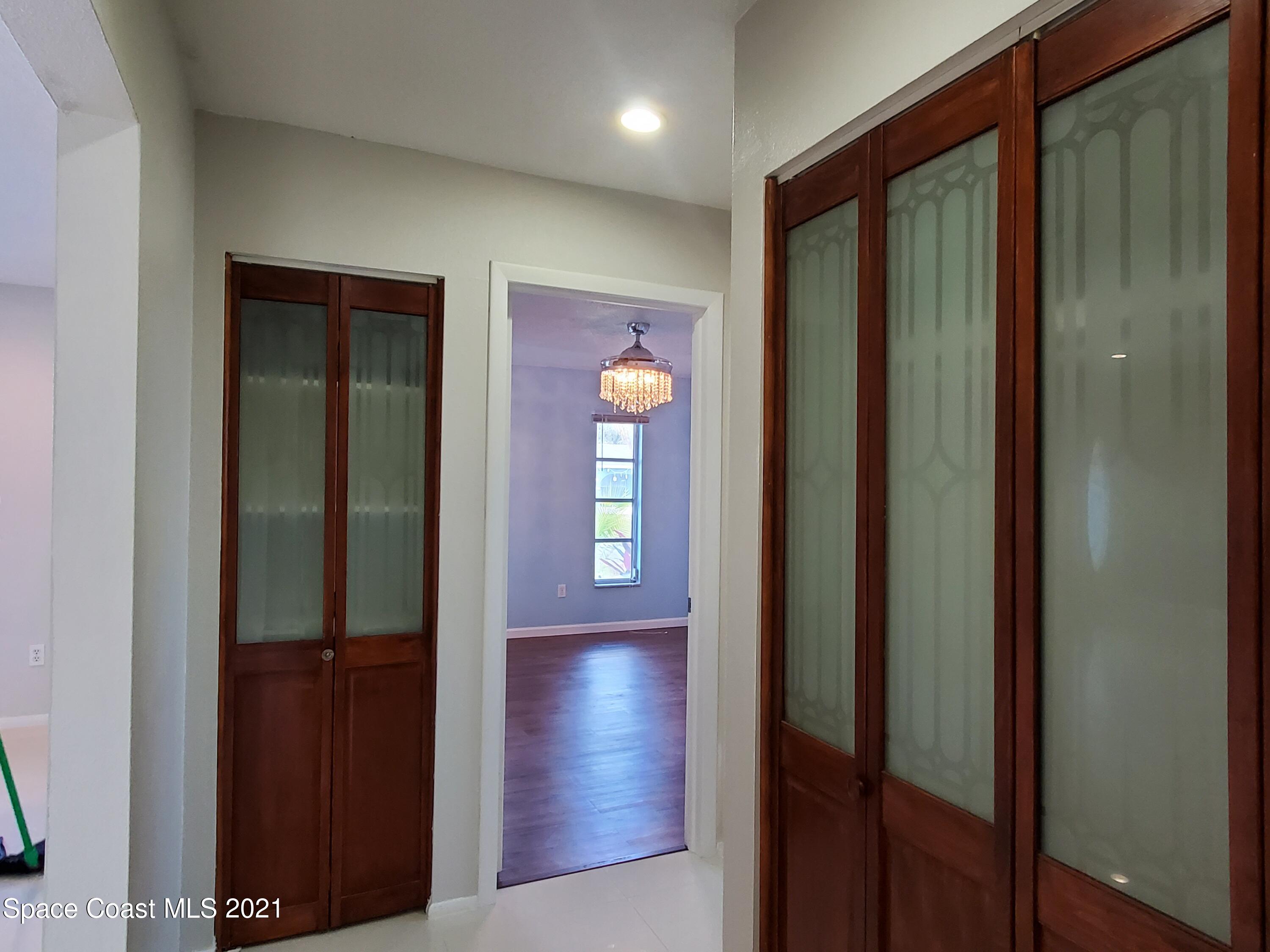 2740 Rhapsody Street Northeast Palm Bay, FL 32905 - Photo 32 of 78 Wood and glass closet doors