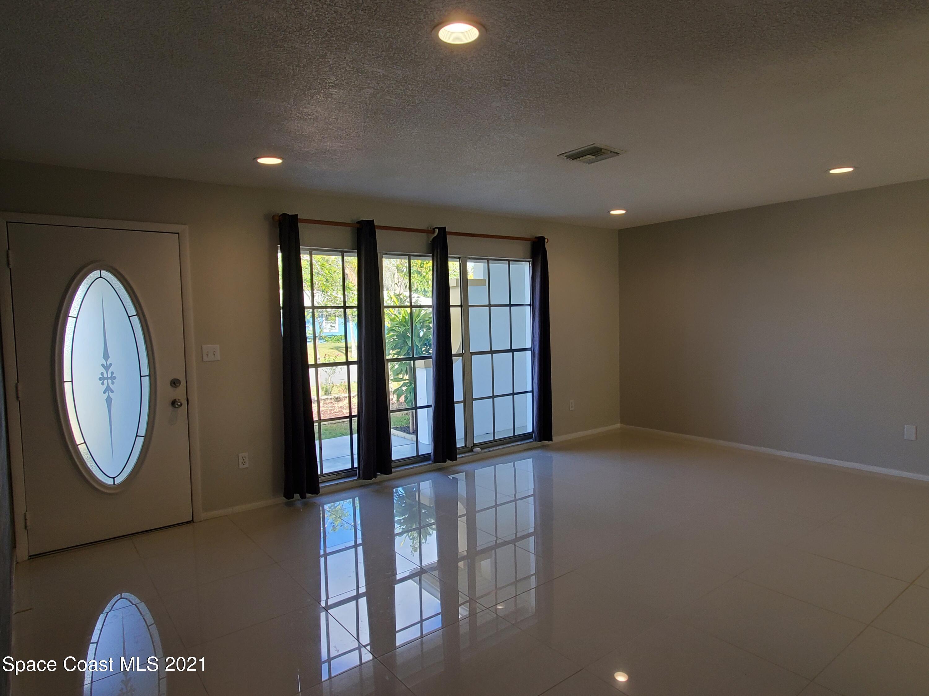 2740 Rhapsody Street Northeast Palm Bay, FL 32905 - Photo 10 of 78 Living Room, front entracnce