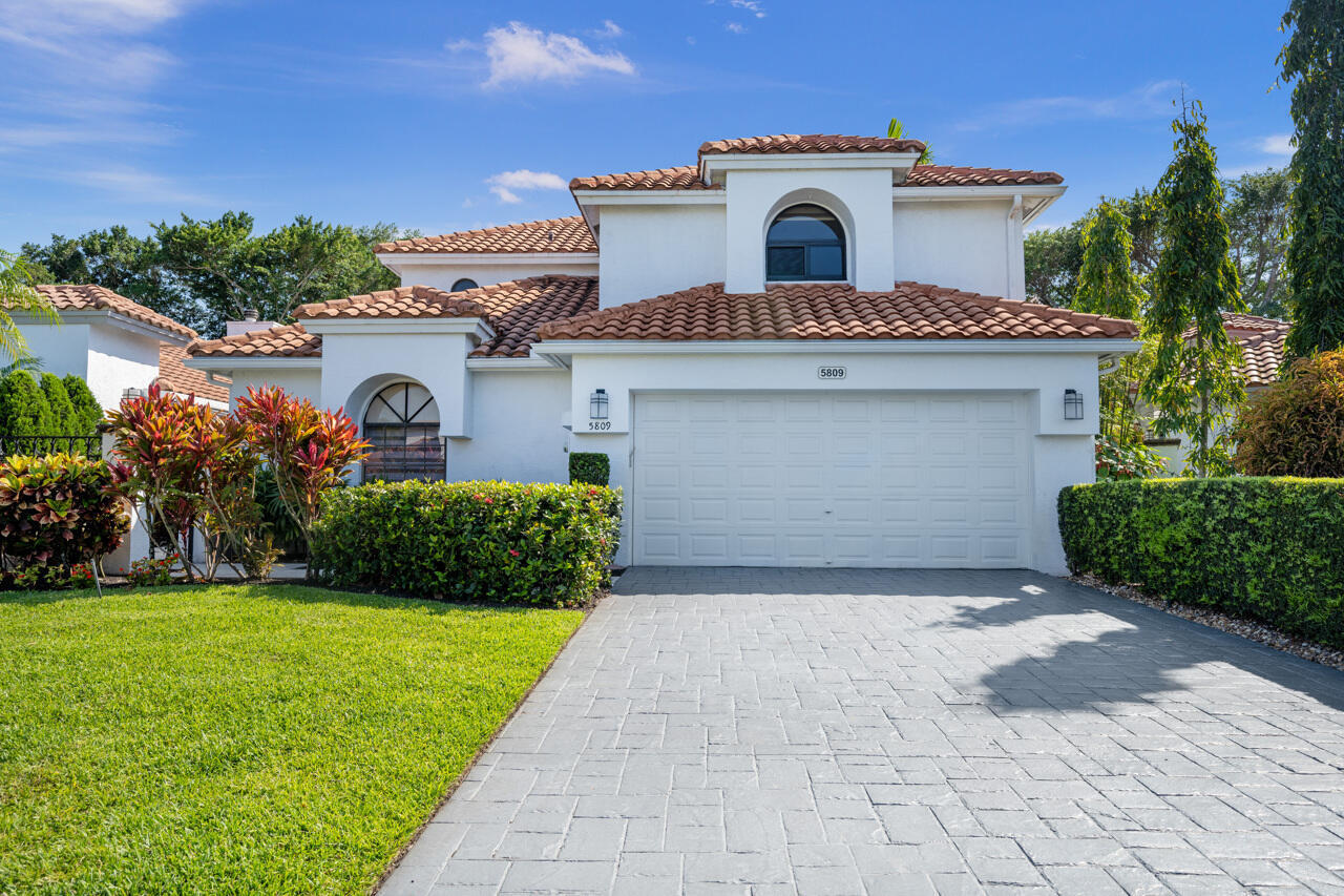 5809 Northwest 21st Way Boca Raton, FL 33496 - Photo 1 of 59 a front view of a house with a garden