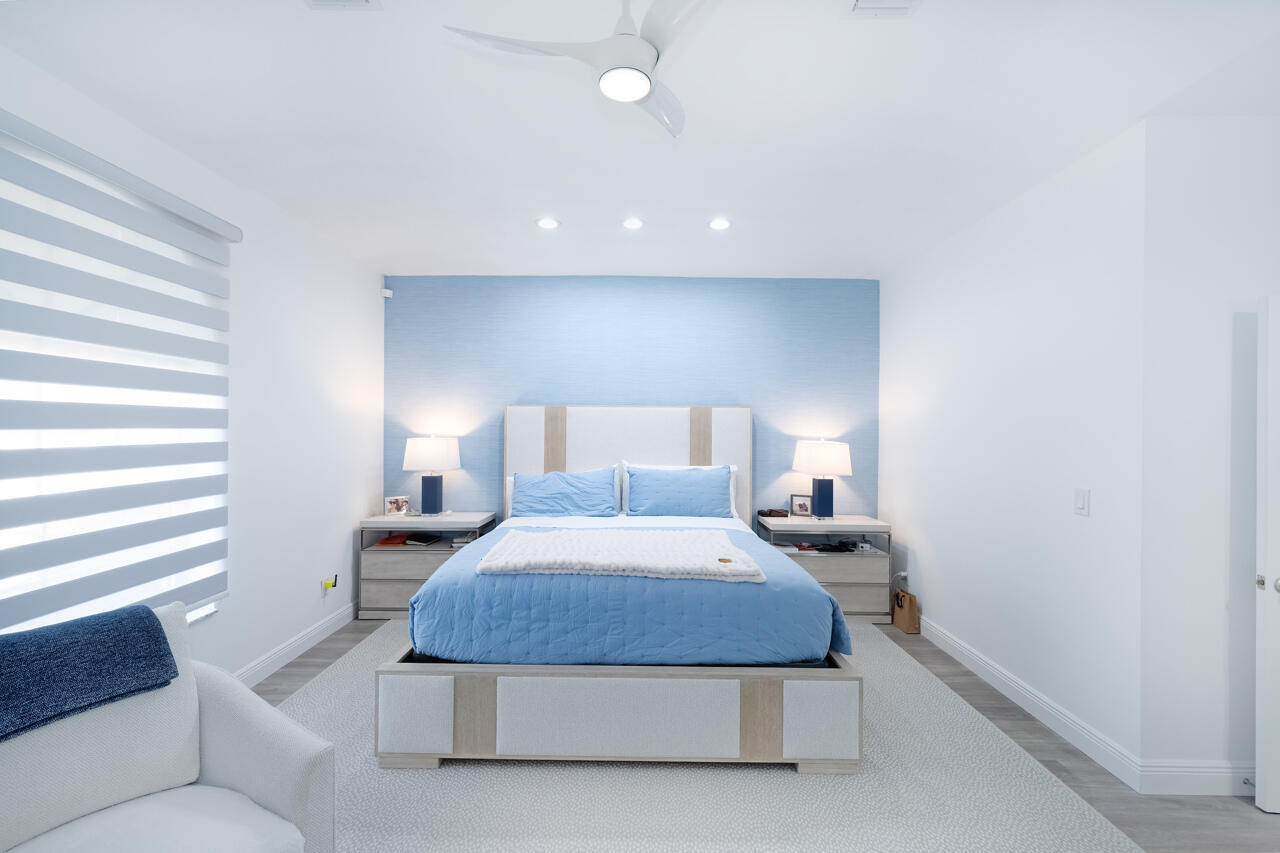 5809 Northwest 21st Way Boca Raton, FL 33496 - Photo 18 of 59 a bedroom with a bed and a couch