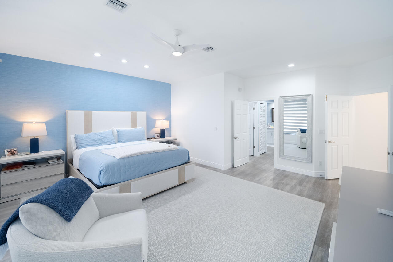 5809 Northwest 21st Way Boca Raton, FL 33496 - Photo 19 of 59 a spacious bedroom with a bed and a couch