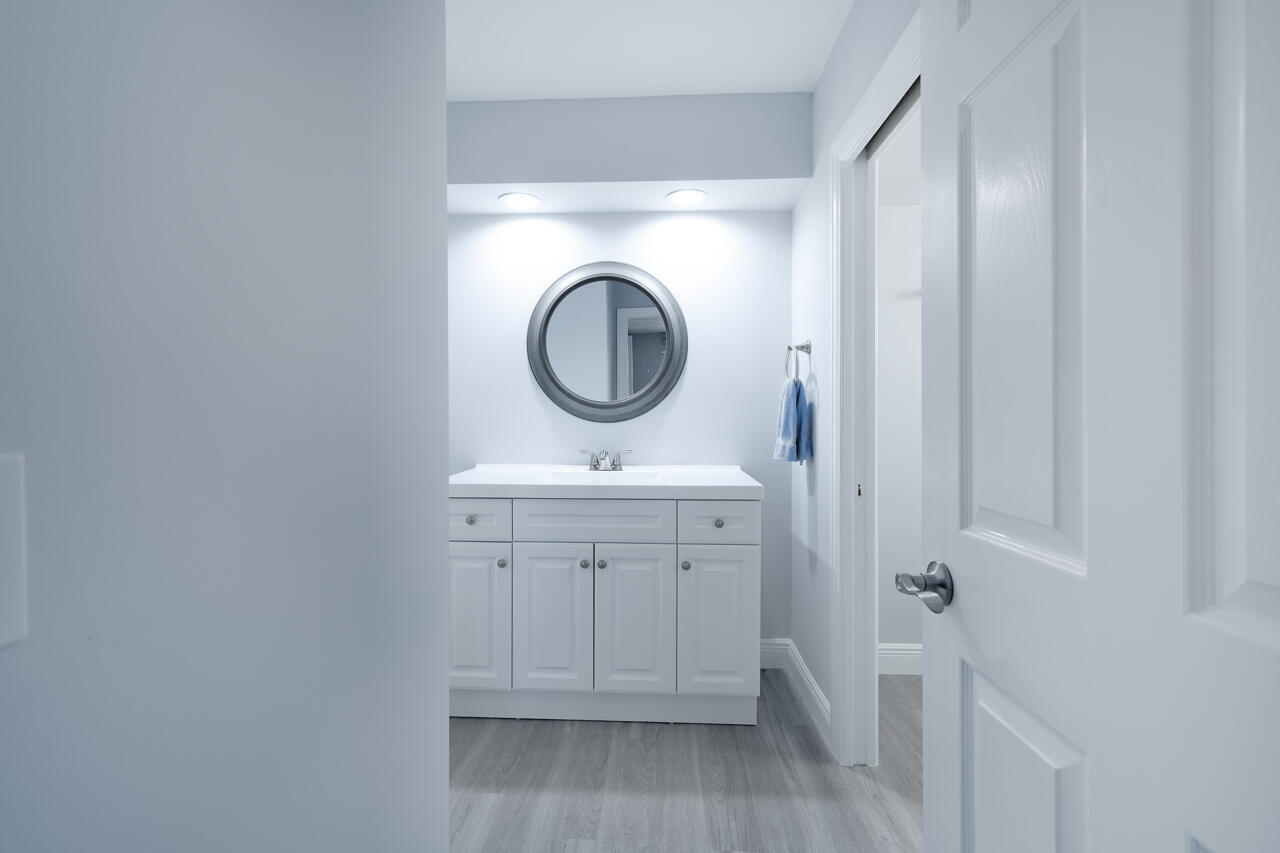 5809 Northwest 21st Way Boca Raton, FL 33496 - Photo 28 of 59 a bathroom with a sink a toilet and a mirror