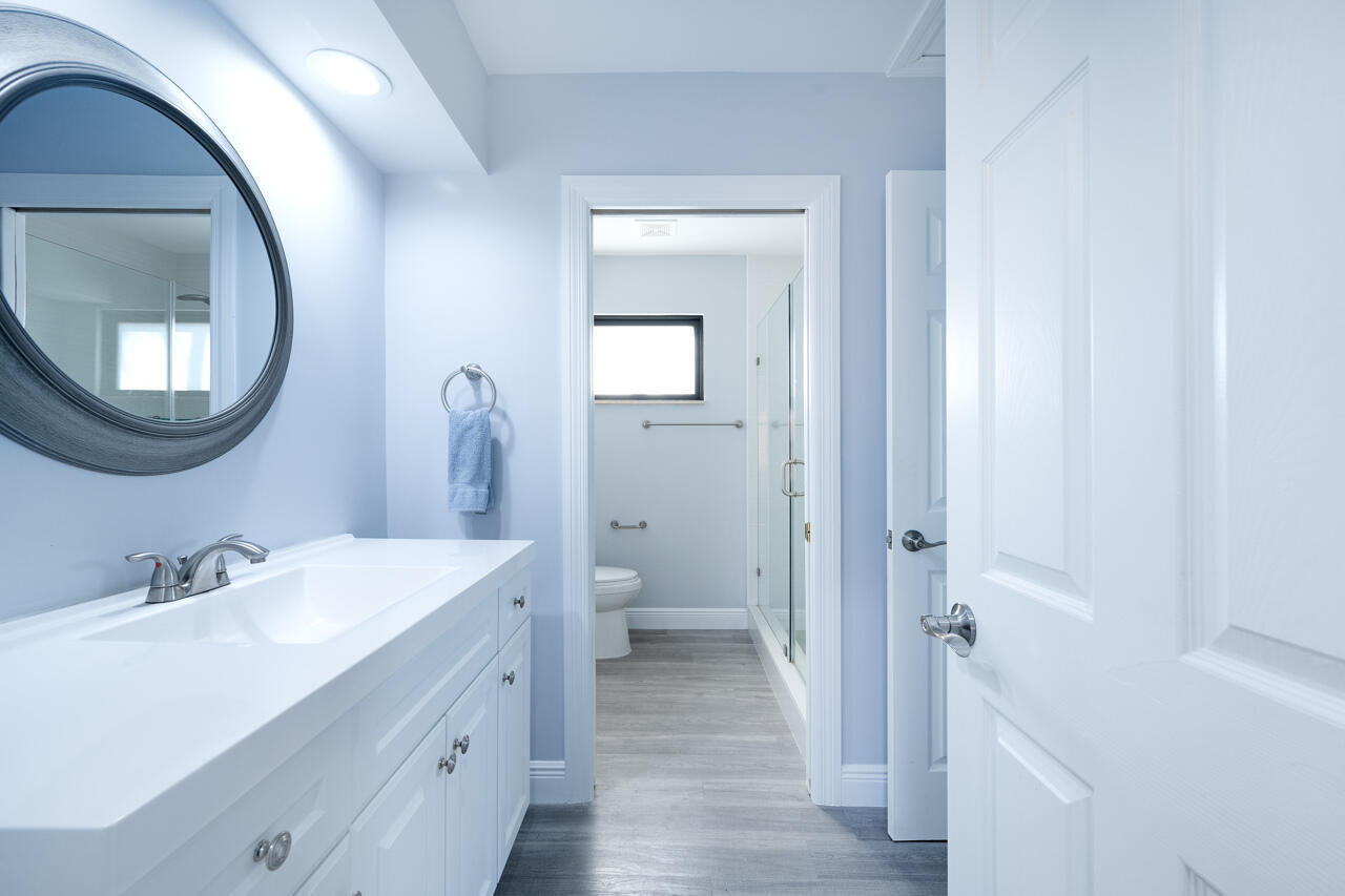 5809 Northwest 21st Way Boca Raton, FL 33496 - Photo 29 of 59 a spacious bathroom with a double vanity sink and a mirror