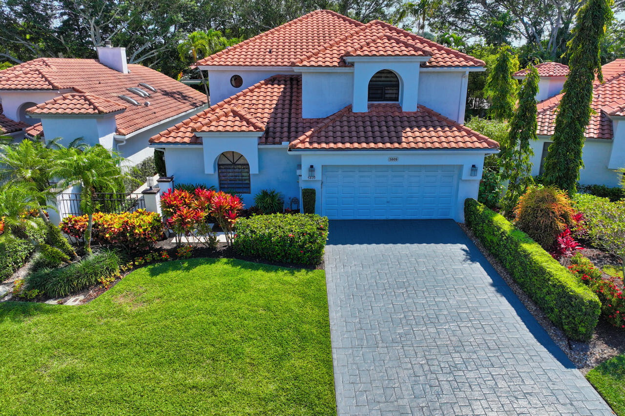5809 Northwest 21st Way Boca Raton, FL 33496 - Photo 41 of 59 a front view of a house with a yard