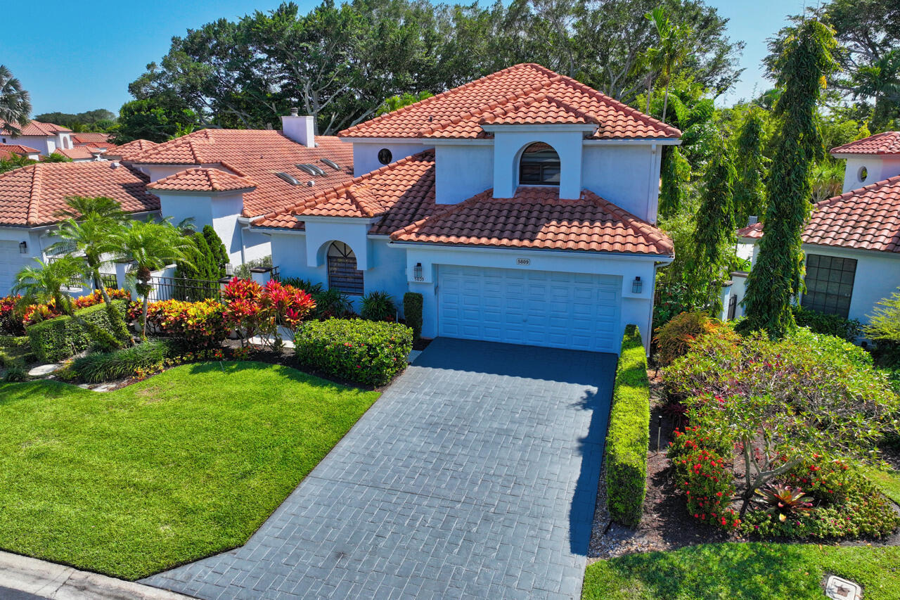 5809 Northwest 21st Way Boca Raton, FL 33496 - Photo 42 of 59 a front view of a house with a garden